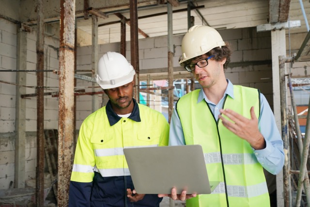 Residential Building. Construction Industry. Caucasian Contractor in the Building.