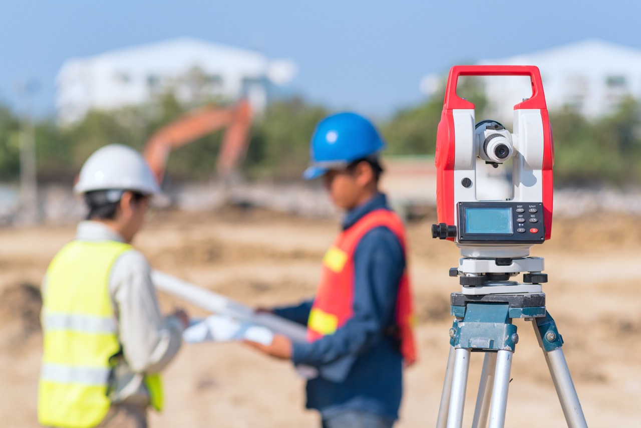 Construction engineer and foreman worker checking construction drawing at construction site for new Infrastructure construction project