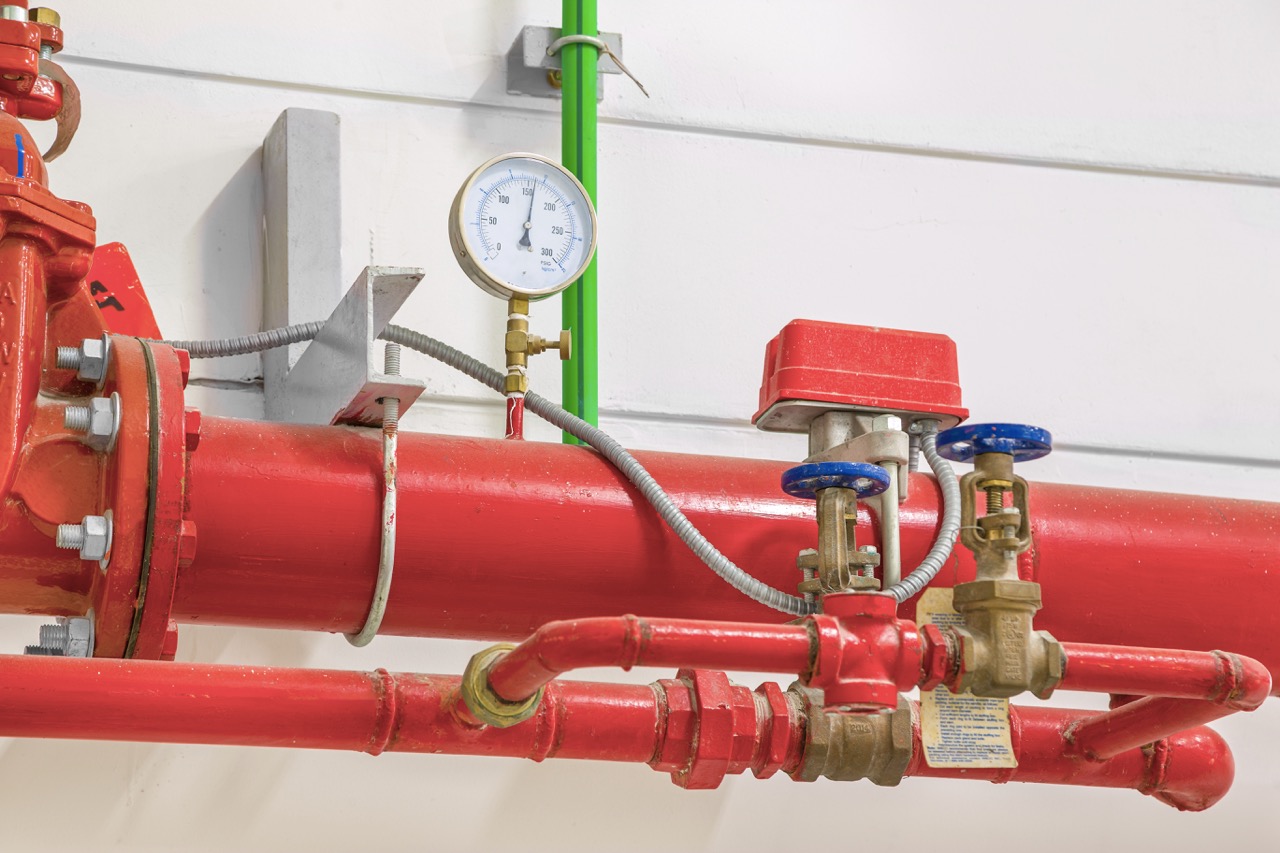 Industrial fire protection system with pressure gauge for measuring pressure, pipeline extinguishing water on the wall.