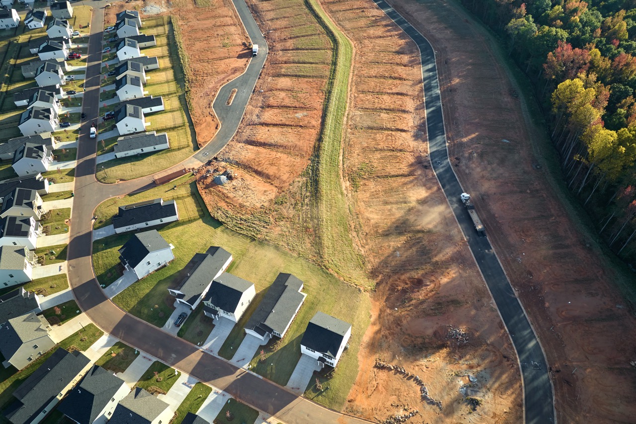 Aerial view of construction site with new tightly packed homes in South Carolina. Family houses as example of real estate development in american suburbs.